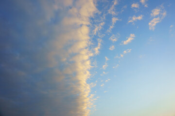 Half of the blue sky is completely clear and half is covered in clouds