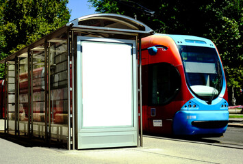 tram and bus stop in urban setting. blank white billboard and poster ad display. advertising concept. glass and aluminum design. blurred city square setting. old buildings in the background