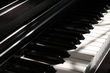 Naklejka premium Sunlight on Piano, keyboard close up instrument playing music, practing and celebrate. Hope