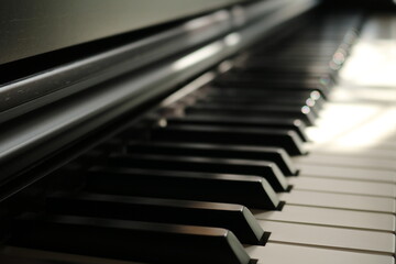 Naklejka premium Sunlight on Piano, keyboard close up instrument playing music, practing and celebrate. Hope