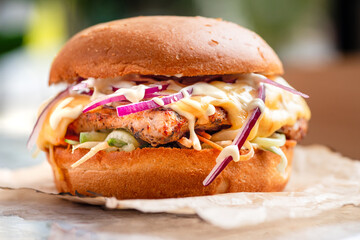 Delicious fresh sandwich with chicken burger, tomato, pickles, onions and lettuce. Free space for text