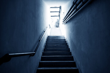 Fototapeta premium Bright light shining at the end of the staircase