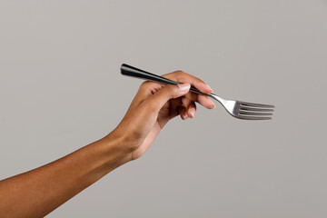 Black female hand showing fork