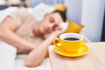 Young hispanic man lying on bed sleeping at bedroom