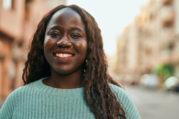 Young african woman smiling happy at the city