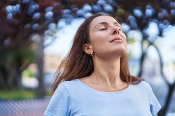 Young woman breathing at park