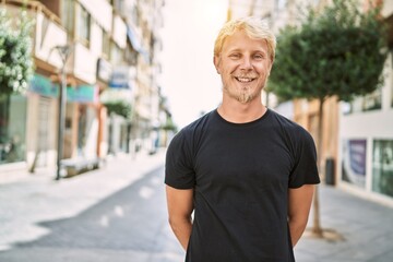 Young caucasian man smiling confident at street