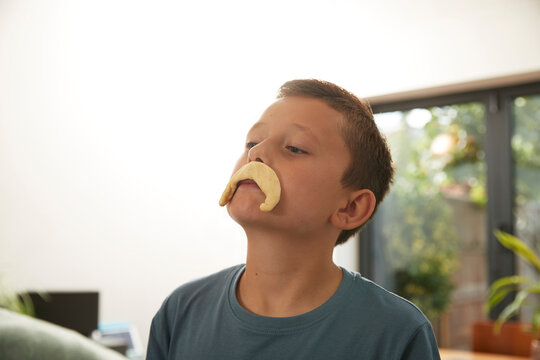 Naklejki Playful boy with dough mustache at home