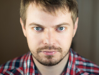 Obraz premium Portrait of a sad man with blue eyes. Selective focus.