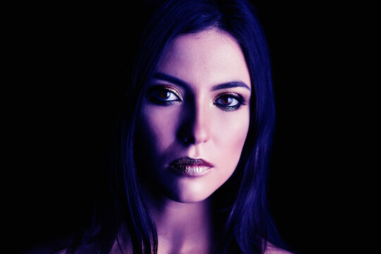 Portrait of a young woman model with violet make-up.
