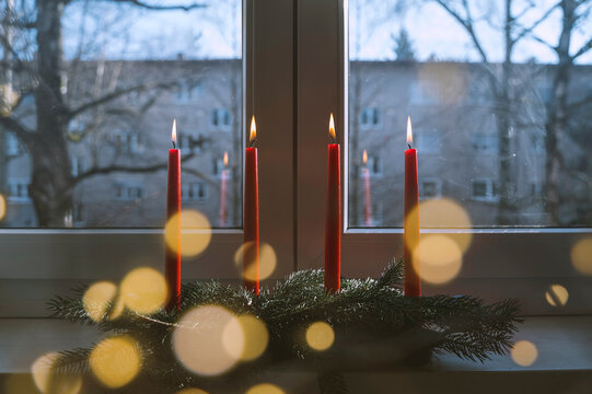 Flaming red candles on table at home in advent