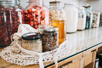 Raw food in mason jars on table at sustainable store