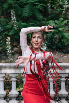 Passionate woman doing flamenco dance in front of railing