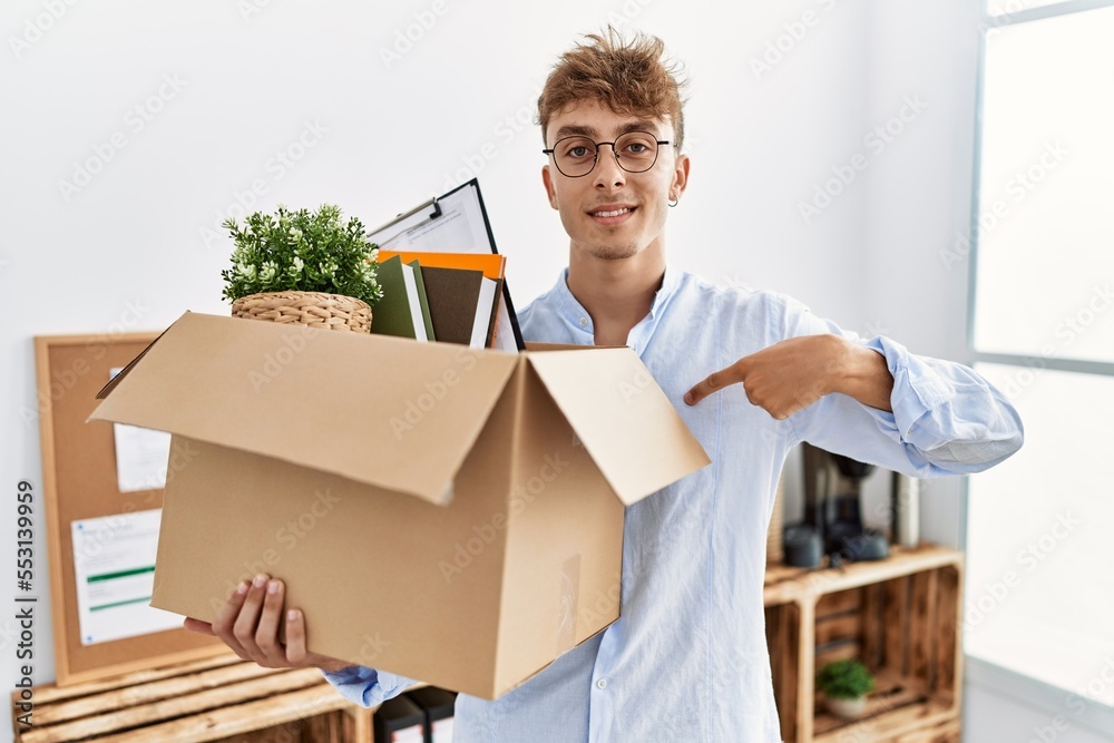 Canvas Prints Young caucasian man holding business box pointing finger to one self smiling happy and proud