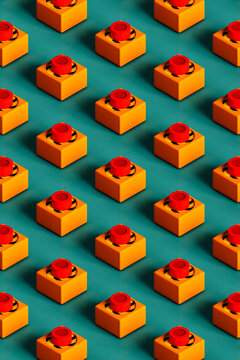 Three dimensional pattern of rows of push buttons flat laid against green background