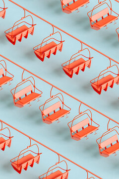 Three dimensional pattern of red ski lifts floating against blue background
