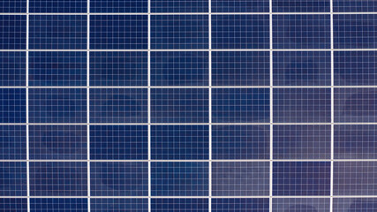 Aerial perpendicular view of solar panels installed on a roof. Solar energy accumulators. Green...
