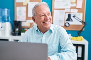 Middle age grey-haired man business worker using laptop working at office