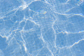 sun flare in beautiful blue swimming pool water