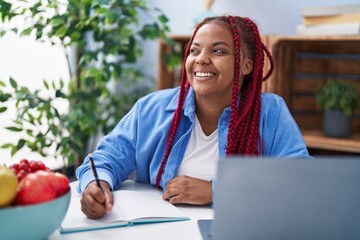 African american woman smiling confident studying at home