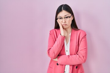 Chinese business young woman wearing glasses thinking looking tired and bored with depression problems with crossed arms.