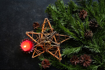 Candle, amulet with deer and pentacle star, fir branches on dark abstract background. Witchcraft...