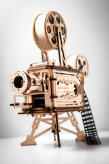 Fototapeta premium wooden model of a cinema projector, old style movie projector over light grey background. High quality photo