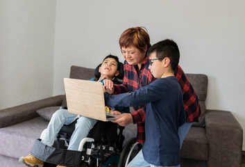 Latin family using laptop for watching a video. Hispanic family with two sons and single mother....