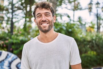 Young hispanic man smiling confident walking at park