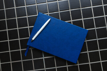 Guestbook and white pencil, top view