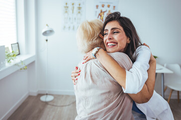 Shot of a young nurse caring for a senior woman. Portrait of optimistic old lady with caring young woman doctor, smiling happy senior mature grandmother with nurse or caregiver  - obrazy, fototapety, plakaty