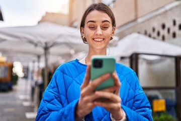 Young caucasian woman smiling confident using smartphone at coffee shop terrace