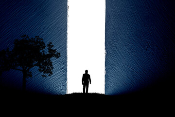 A silhouette of a man in nature next to a tree, walking towards a bright light in the opened huge wall. A light in the end of a tunnel. The concept of success, freedom, choice, open mind, meditation.