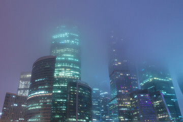 Mystical cityscape. Skyscrapers in the fog. Foggy view of the towers of the Moscow International Business Center Moscow City.