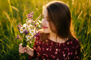 young happy beautiful couple in love walking together on grass and trees park landscape