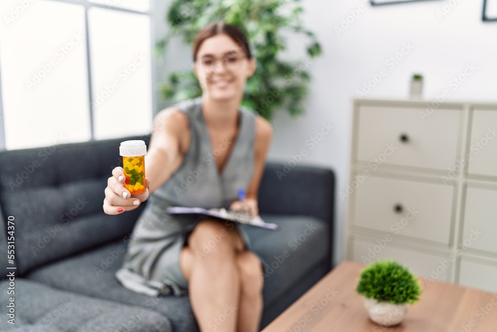 Sticker young hispanic woman doing psychiatry treatment holding pills at pshychiatry clinic