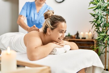 Woman couple smiling confident having back massage at beauty center - obrazy, fototapety, plakaty
