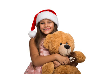 Smiling little girl holding a teddy bear