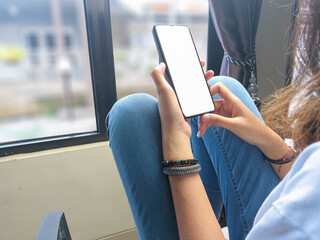 Close-up of a woman hand holding a smartphone white screen is blank .Mockup.