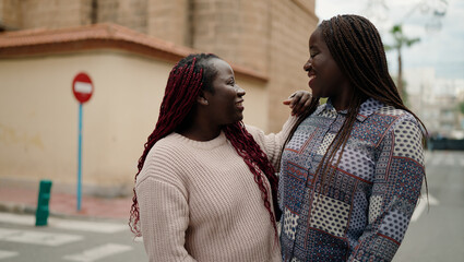 Fototapeta premium Two african american friends smiling confident standing together at street