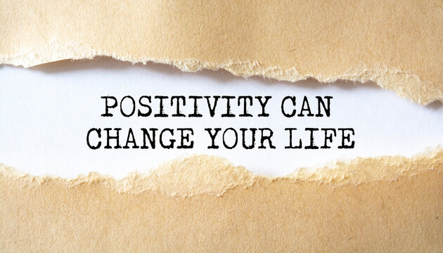 Positivity Can Change Your Life word written under torn paper.