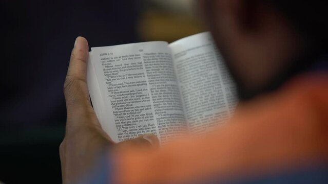 black prisoner african american inmate reading a Bible in prison jail shot on Sony A7III mirrorless camera