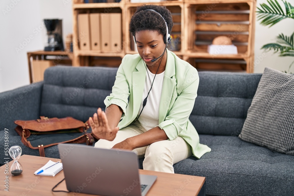 Sticker african american woman doing online session at consultation office with open hand doing stop sign wi