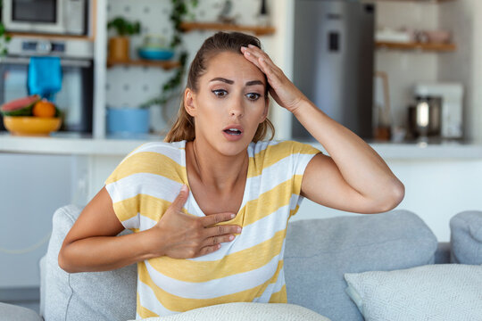 Breathing, respiratory problem, asthma attack, pressure, chest pain, sun stroke, dizziness concept. portrait of woman received heatstroke in hot summer weather, touching her forehead