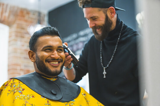 Professional hairdresser cutting hair of the male client. High quality photo