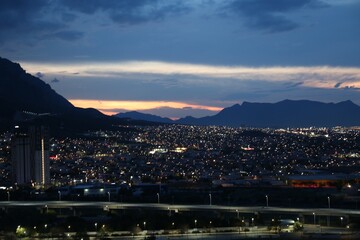 Fototapeta premium Picturesque view of city and mountains in evening