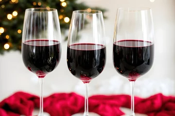 Fotobehang Christmas drink red wine glass with decoration tree. Holiday celebration party with wineglass of winter festive beverage. Generative AI © Great Choice