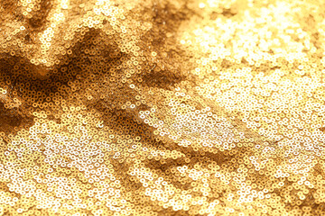 Beautiful golden shiny cloth with sequins as background, closeup