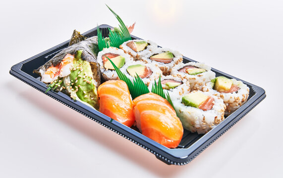  Delivery tray of delicious sushi over isolated white background
