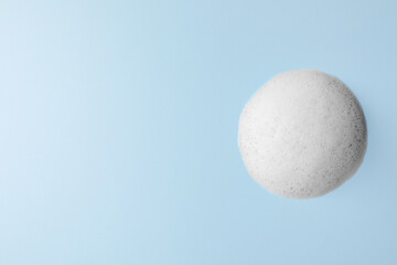 Foam sample on light blue background, top view. Space for text